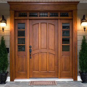 A beautiful wooden door graces the entrance to a west coast contemporary home.